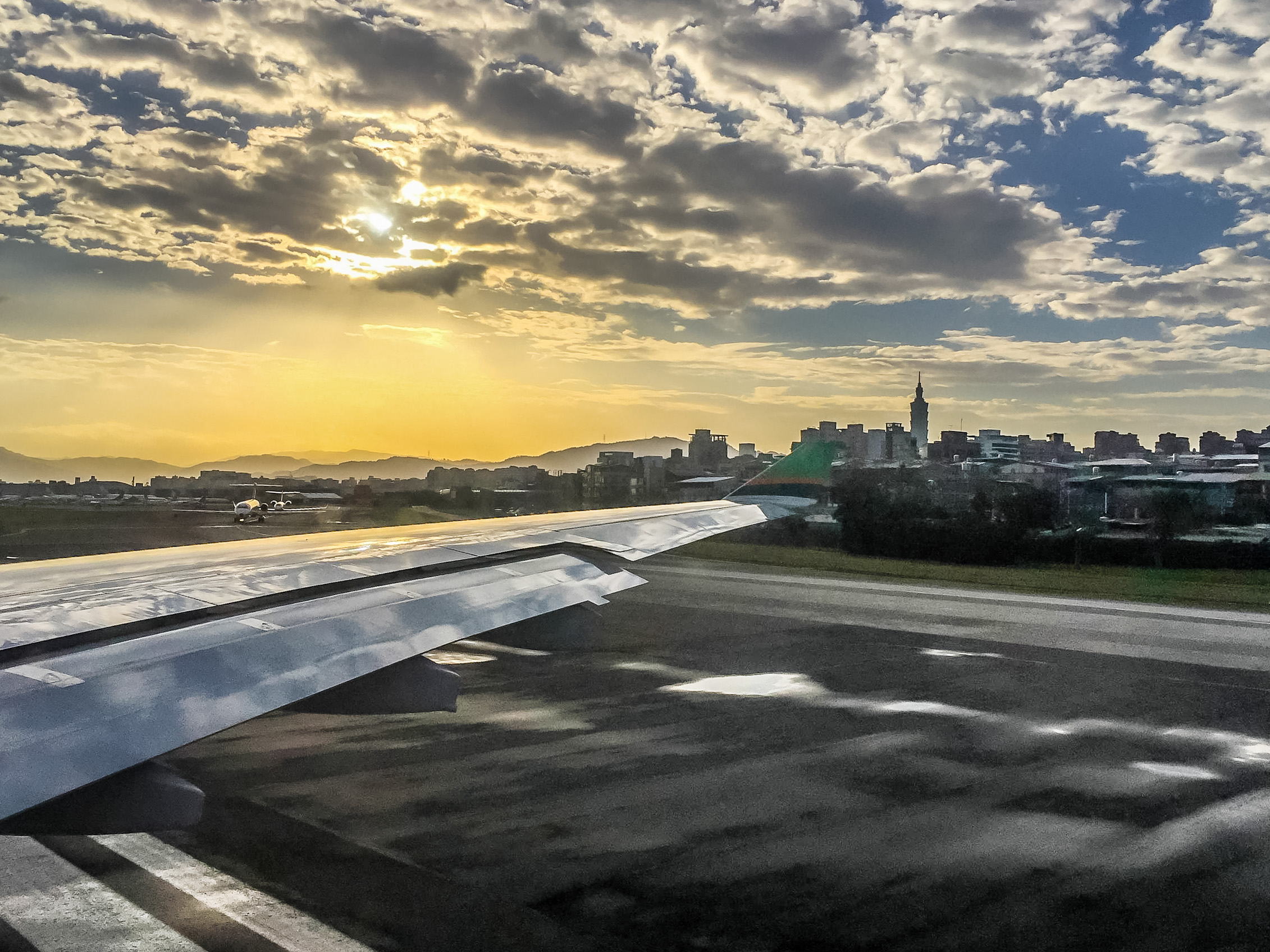 旅の途中、飛行機の窓から見た夕暮れの街並み